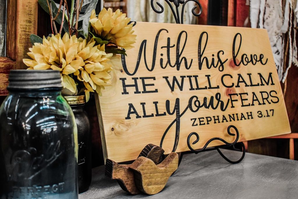 a-wooden-sign-that-says-with-his-love-he-will-calm-all-your-tears-lslyvgznqe8