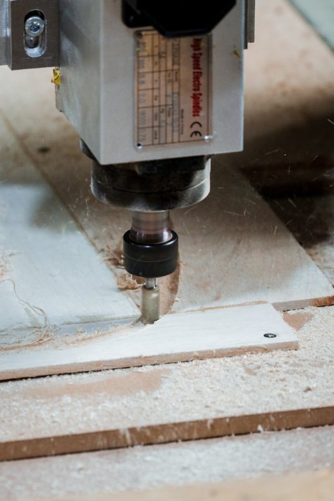 Close-up of a milling machine cutting wood in a workshop setting.